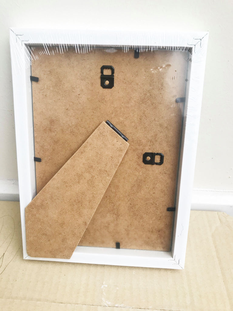 a picture frame with a pair of scissors in it