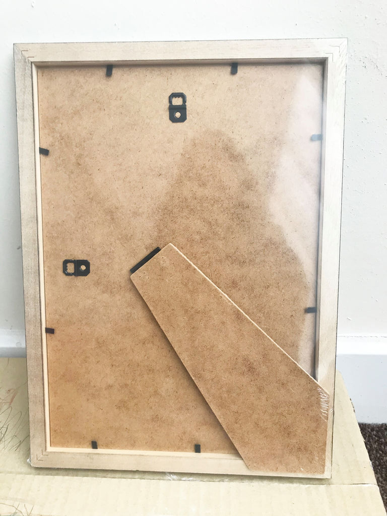a clock made out of cardboard sitting on top of a cardboard box